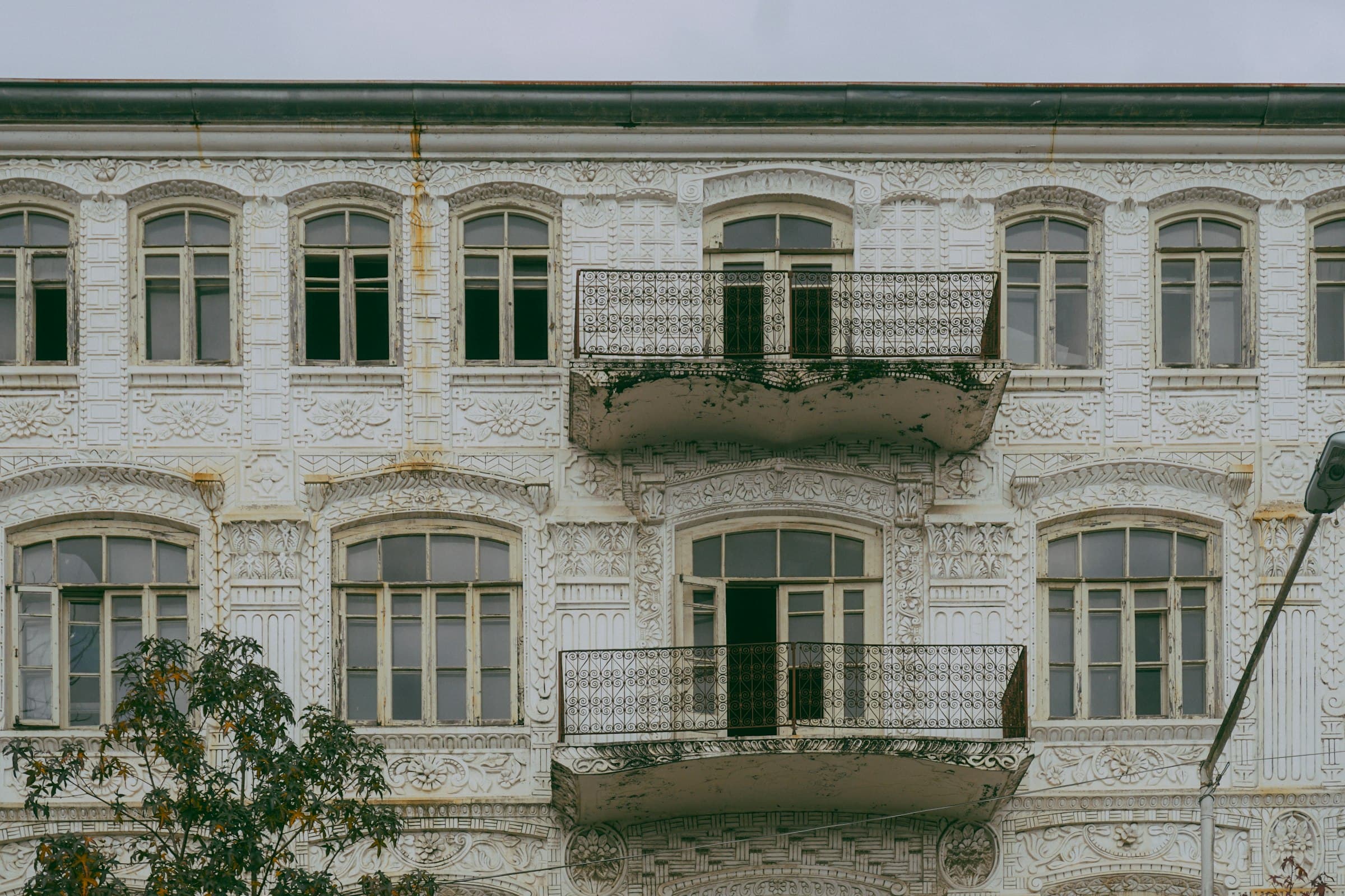 Altbaufassade mit Stuck und zwei Balkonen